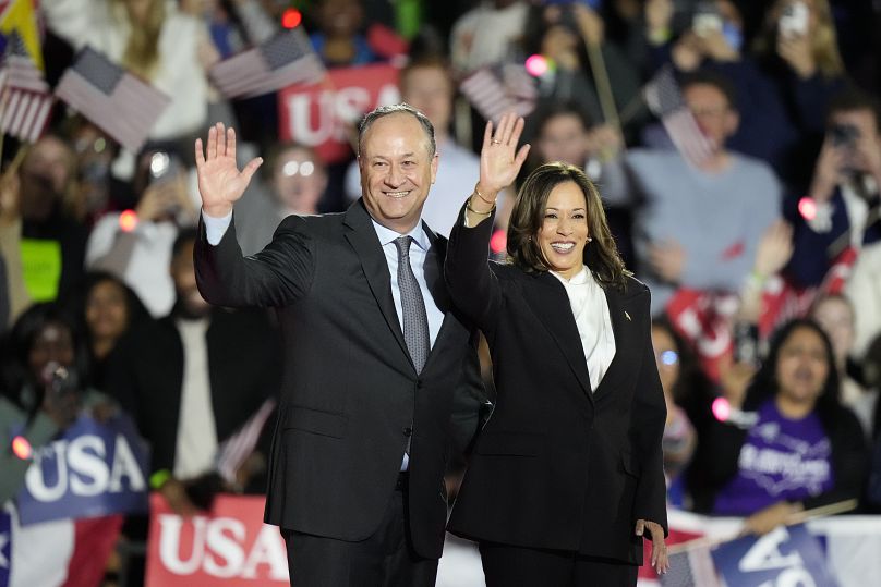 Vice President Kamala Harris and her husband Doug Emhoff wave to the crowd during a campaign event at the Ellipse near the White House in Washington.