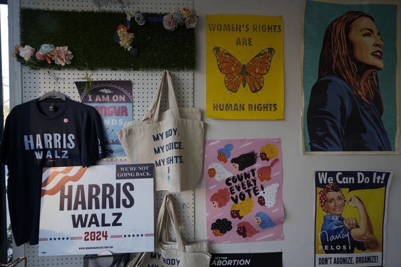 Political posters decorate the walls of the Women's March Foundation during a phone bank in support of Democratic presidential nominee Vice President Kamala Harris. 