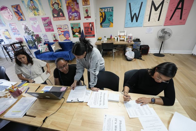 Emiliana Guereca, founder and president of the Women's March Foundation, left, works at a phone bank calling voters to encourage them to vote for Kamala Harris. 