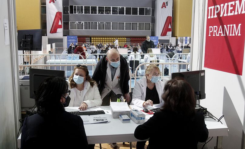 Doctors and health workers talk to people before their vaccination at the center for mass vaccination against COVID-19, at A1 Arena in Skopje, North Macedonia.