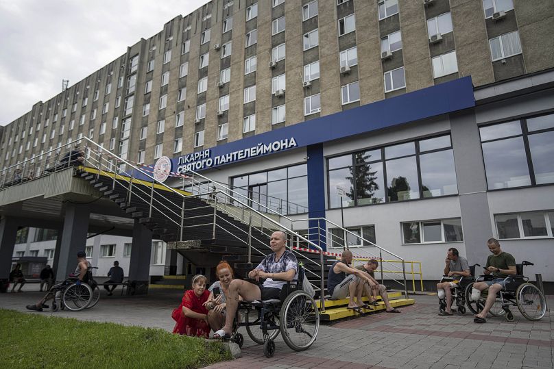 Ukrainian army veterans rest with their families and comrades outside St. Panteleimon hospital in Lviv, Ukraine. 