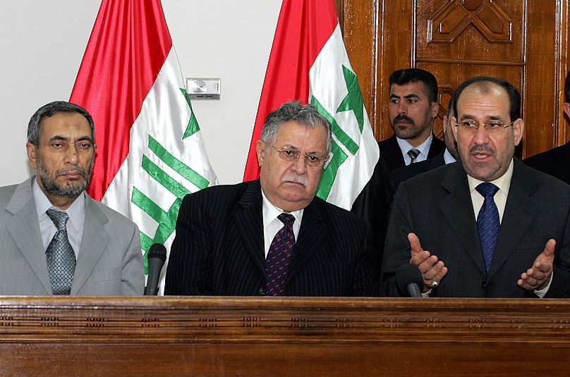 رئيس البرلمان العراقي محمود المشهداني، إلى اليسار، والرئيس جلال طالباني، في الوسط، يستمعان إلى رئيس وزراء البلاد نوري المالكي في بغداد، العراق، 22 تموز/يوليو 2006.