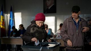 A woman prepares to cast her vote during a presidential election runoff, in Chisinau, Moldova, Sunday, Nov. 3, 2024.