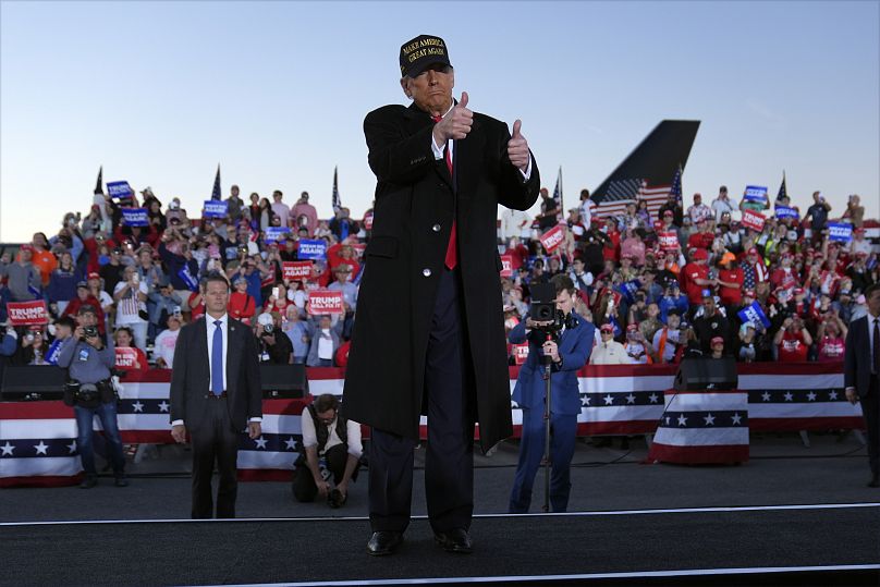 Former President Donald Trump gestures at a campaign rally at Kinston Regional Jetport, 3 November, 2024