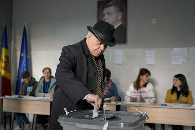 A man casts his ballot at a polling station in the capital Chișinău, 3 November, 2024