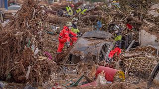 Emergency services remove cars in an area affected by floods in Catarroja, 3 November 2024