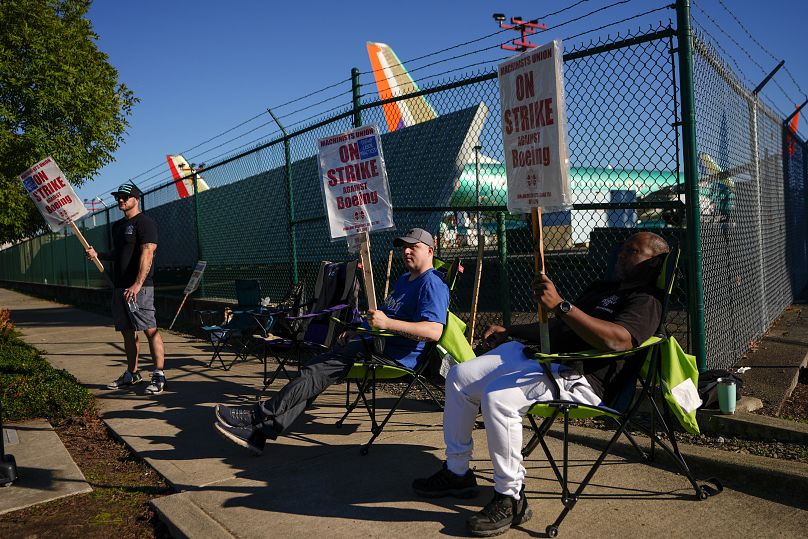 Machinists carry placards outside the company's facilities in Renton, Washington