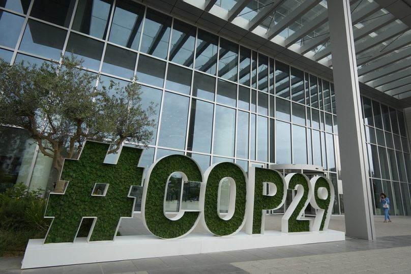 A sign for COP29, the United Nations Climate Change Conference, sits outside the headquarters in Baku, Azerbaijan.