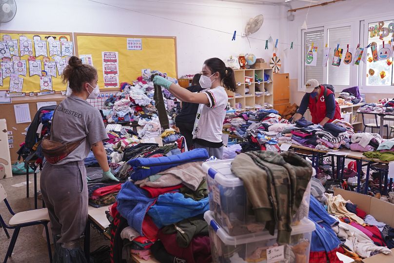 Clothes are sorted in school used as a distribution centre for people needing clothes and food on the outskirts of Valencia, Spain, Monday, Nov. 4, 2024.