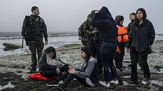 A group of Kurdish migrants from Iran and Iraq who failed in their attempt to reach the United Kingdom by boat rest on the beach of Ambleteuse, northern France on May 19 2024.