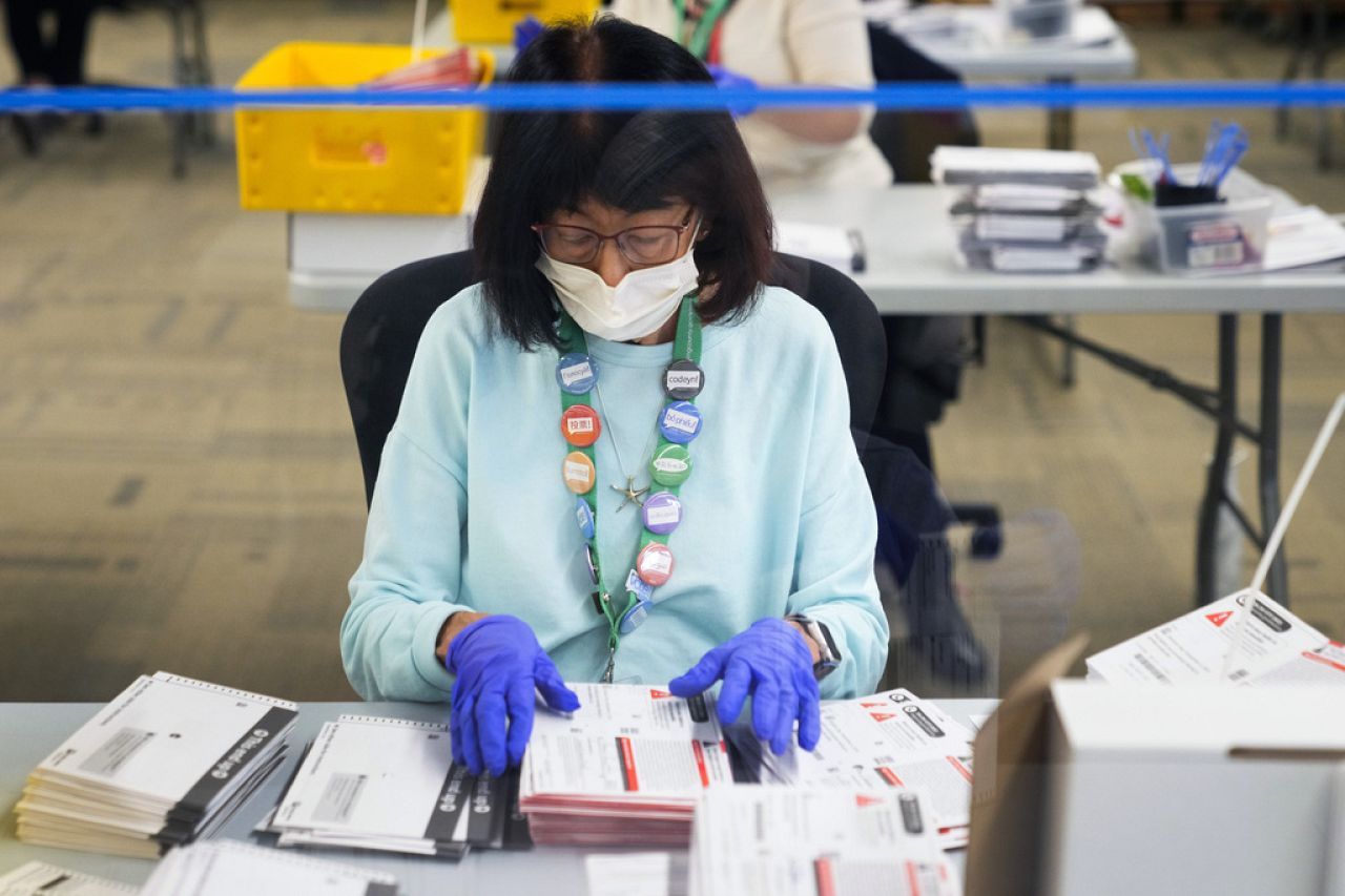 Betty Noro-Kobayashi works to open ballots at King County Elections headquarters on Election Day