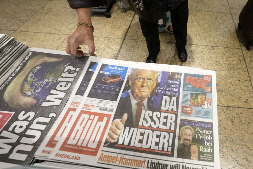 Germany's biggest tabloid newspaper BILD, with President-elect Donald Trump on the frontpage and headlines reading "There he is again!", is seen at a station kiosk in Cologne.