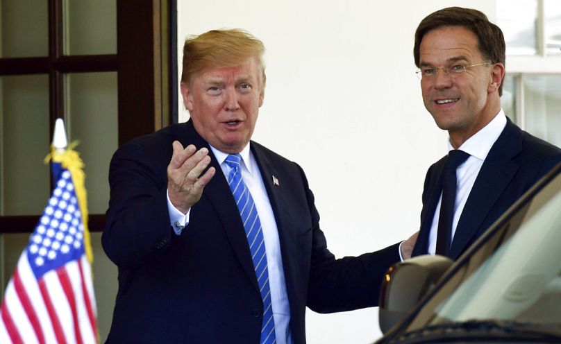 President Donald Trump, left, welcomes Dutch Prime Minister Mark Rutte, right, to the West Wing of the White House in Washington, Monday, July 2, 2018. (AP Photo/Susan Walsh)