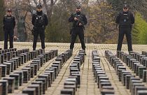 File photo: Police officers stand by part of a haul of cocaine, displayed in the patio of a police station in Madrid, Spain, Tuesday, Dec. 12, 2023.