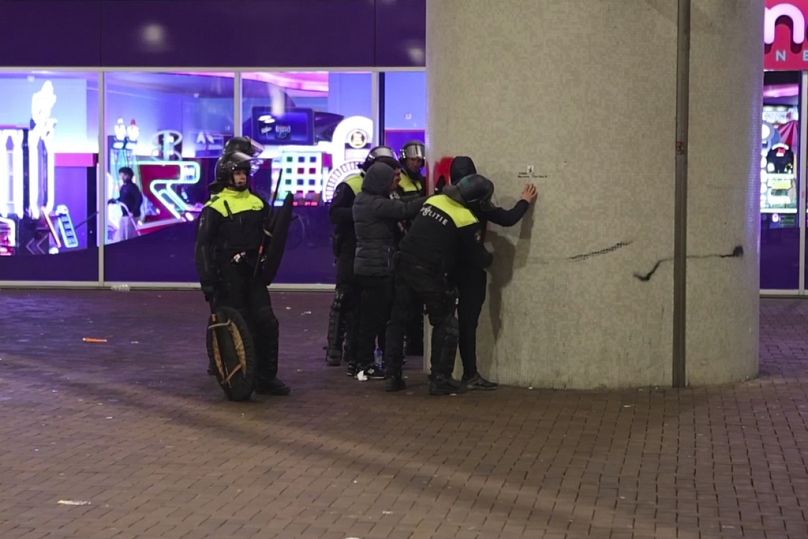 In this image taken from video, police frisk pro-Palestinian supporters near the Ajax stadium in Amsterdam, the Netherlands, Thursday, Nov. 7, 2024.