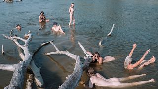A crew from Liquid Becoming cool off during river voyage exploration 