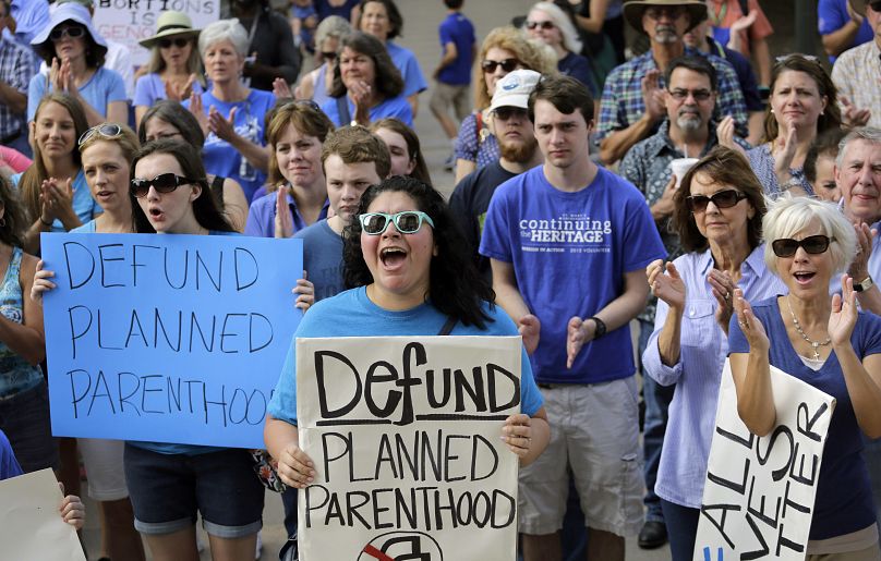 Erica Canaut, center, cheers as she and other anti-abortion activists rally on the steps of the Texas Capitol in Austin in 2015