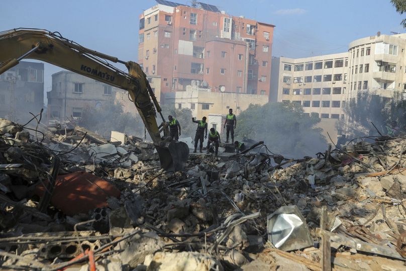 Emergency workers search for survivors at the scene of an Israeli airstrike in Tyre, southern Lebanon, Saturday, Nov. 9, 2024. (AP Photo/Mohammad Zaatari)