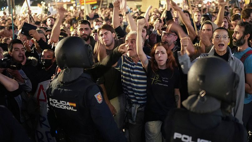 Demonstrators confront riot police at the protest in front of Valencia's city hall.