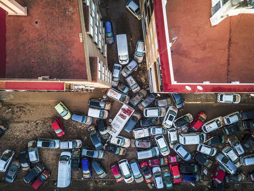 Vehicles pile up in the streets after flooding caused by late Tuesday and early Wednesday storm that left hundreds dead or missing in Alfafar, 2 November, 2024