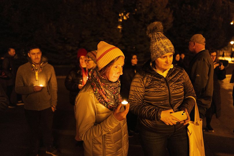 Friends hold candles while remembering Mackenzie Michalski, an 31-year-old American tourist who was murdered while on holiday in Budapest, 9 November, 2024