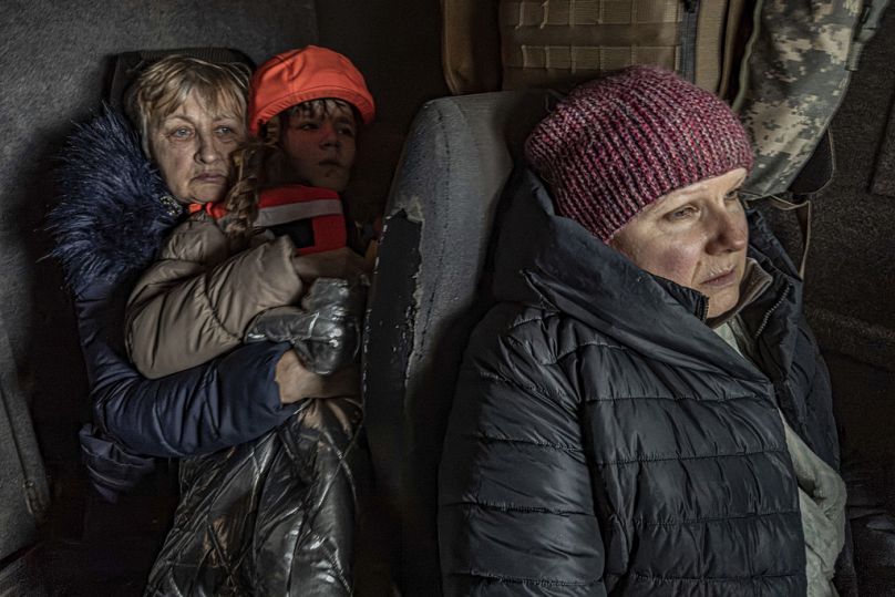 Katia, 11, with her grandmother and mother sit in an armoured minivan during evacuation by the "White Angels"in Kurakhove, Donetsk region, Ukraine, on Nov. 4, 2024