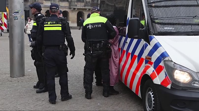 Police detain a person next to the place where Maccabi Tel Aviv supporters gathered ahead of the Europa League soccer match between their team and Ajax, 7 November, 2024