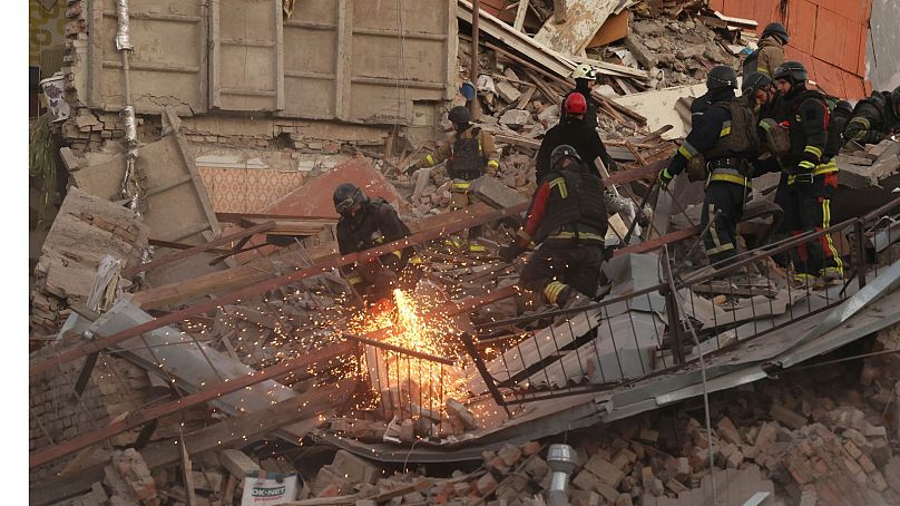 Rescue workers clear the rubble of a residential building destroyed by a Russian airstrike in Zaporizhzhia, Ukraine.