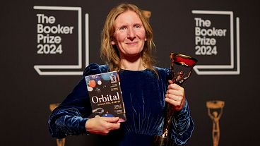 Samantha Harvey poses with the trophy and her book "Orbital" after winning the Booker Prize award 2024, in London. Samantha Harvey poses with the trophy and her book "Orbital" after winning the Booker Prize award 2024, in London.
