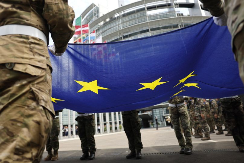 Military hold the European Union flag as they participate in a flag raising ceremony in front of the European Parliament in Strasbourg, July 2024