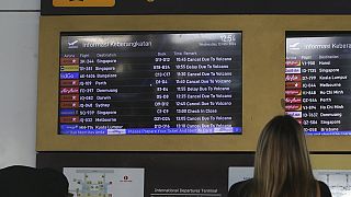 Passenger checking an information board indicating cancelled flights due to the eruption of Mount Lewotobi Laki-Laki, Bali International Airport, Indonesia, 13.13.2024