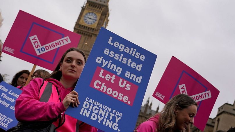 A small demonstration by people advocating assisted dying hold a protest outside the Hoses of Parliament, 2024. 