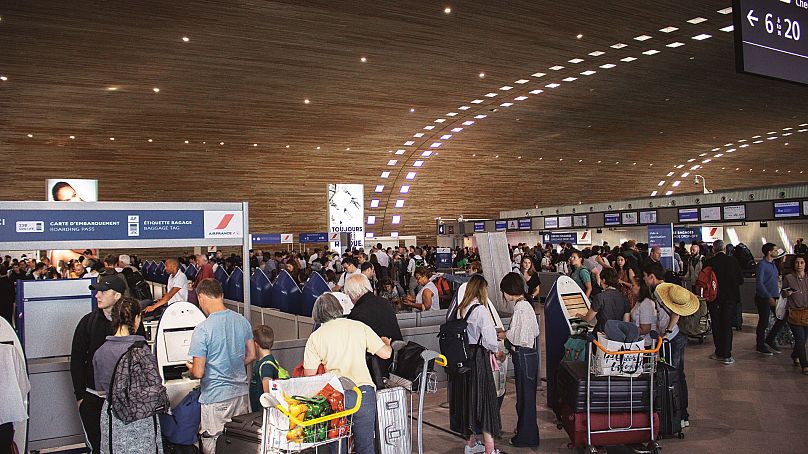 Passengers wait at a French airport