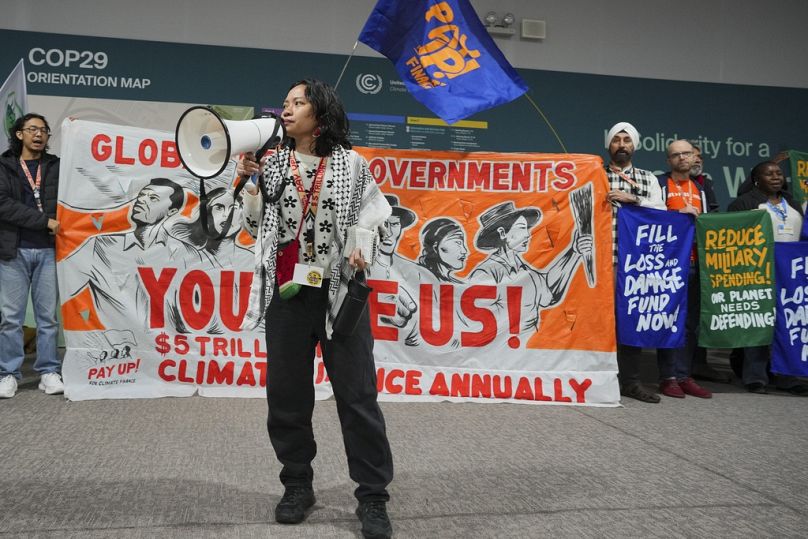 Activists participate in a demonstration calling for climate finance.