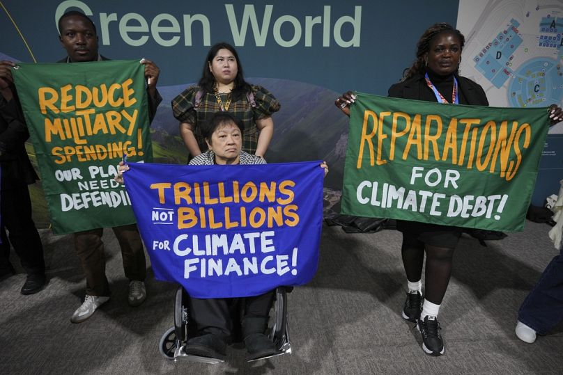 Activists participate in a demonstration calling for climate finance at COP29.