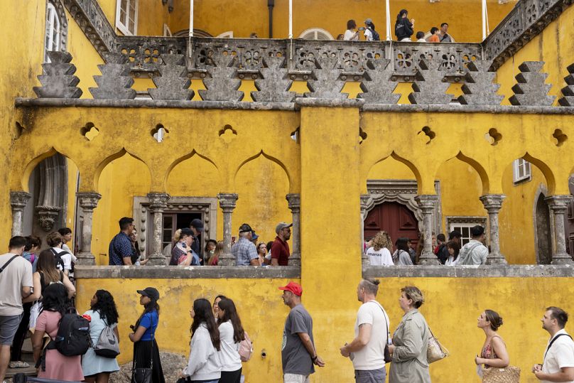 Tourists queue to visit inside Pena Palace in Sintra, near Lisbon