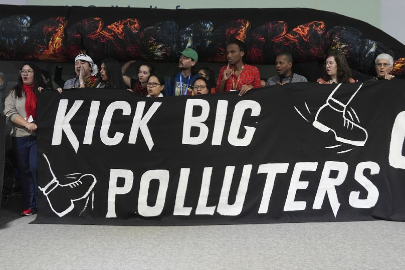 Activists participate in a demonstration against fossil fuels at COP29.