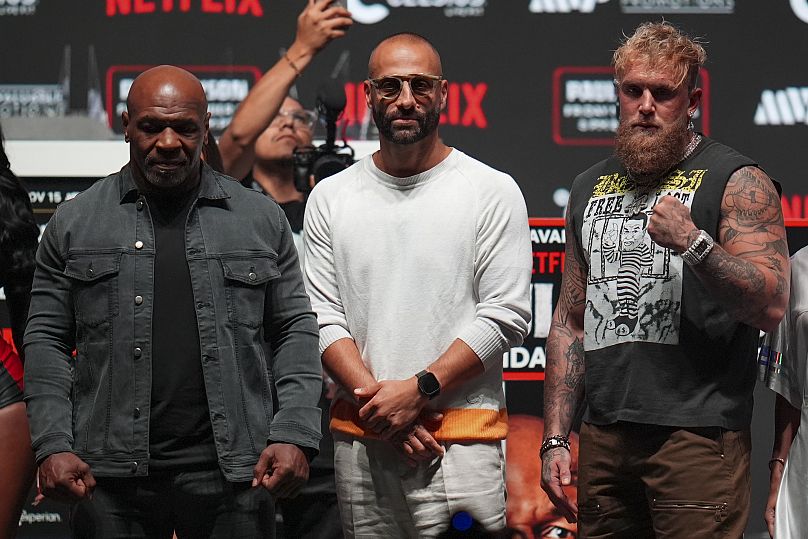 Mike Tyson, left, and Jake Paul, right, pose for photographs during a news conference ahead of their fight, Wednesday, 13 November 2024.