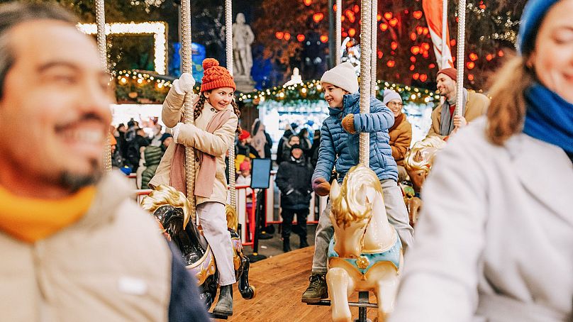 Children enjoy a festive carousel ride in Vienna