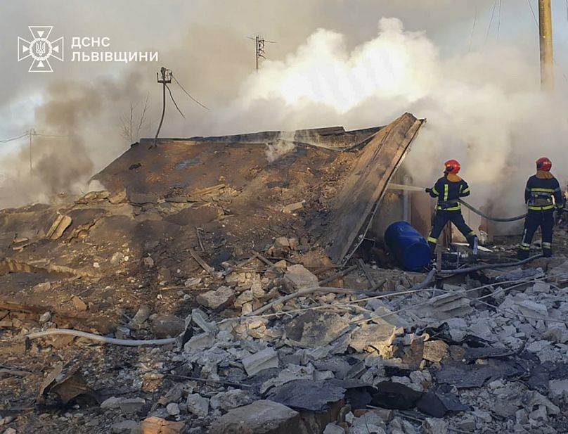  emergency services personnel work to extinguish a fire following a Russian rocket attack in Lviv, Ukraine, Sunday, Nov. 17, 2024. (Ukrainian Emergency Service via AP)