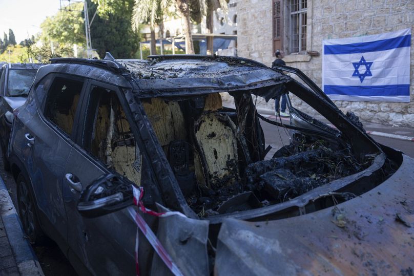 A destroyed car that was hit by a missile fired from Lebanon on Saturday, in Haifa, northern Israel, Sunday, Nov. 17, 2024. (AP Photo/Ohad Zwigenberg)