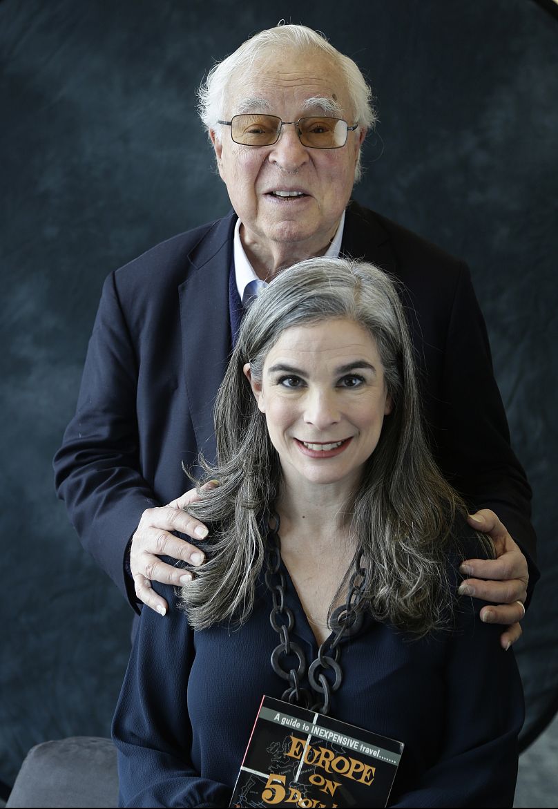 Arthur Frommer, background, poses with his daughter, Pauline, in New York, Jan. 6, 2017. 