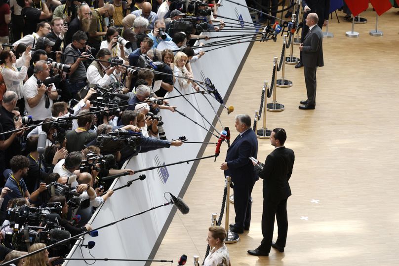 Hungary's Prime Minister Viktor Orban speaks with the media as he arrives for an EU summit in Brussels, June 2024