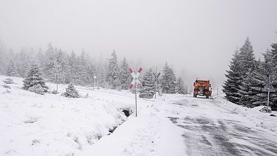 A truck drives along an icy road.