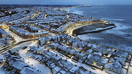 Overnight snow covers Cullercoats Bay in North Tyneside, UK