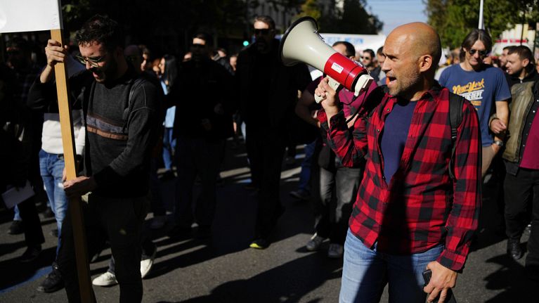 Protesters take part in rally, during a nationwide general strike organized by private and public sector unions demanding for better wages, in Athens, Wednesday, Nov. 20
