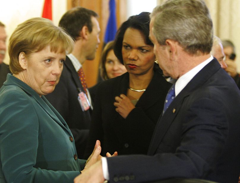 US President George W. Bush and Secretary of State Condoleezza Rice talk with German Chancellor Angela Merkel, at the NATO Summit conference in Bucharest, 2008.