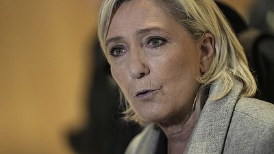 French far-right leader Marine Le Pen speaks to the media as she arrives at a court house in Paris, France, Sept. 30, 2024