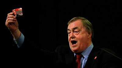 Former Deputy leader of the Britain's Labour Party, John Prescott, holds up his Labour Party membership card in London, 24 August 2015.