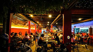 Foreign tourists have a drink at a night club at Nana Backpack hostel in Vang Vieng, Laos, Tuesday, Nov. 19, 2024.